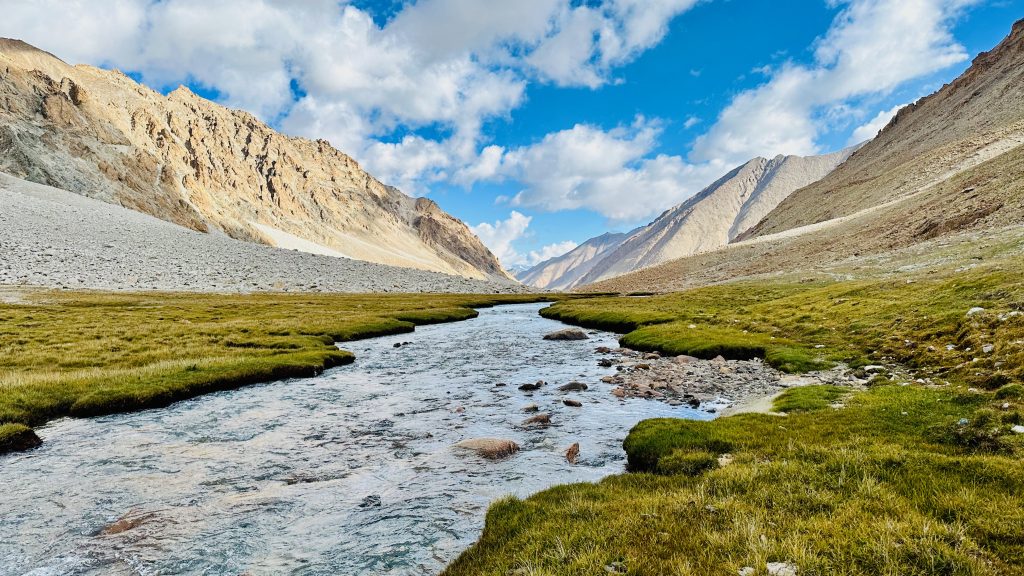 glacial stream, river, ice water, icy water, panaromic view, mountain, clouds, valley